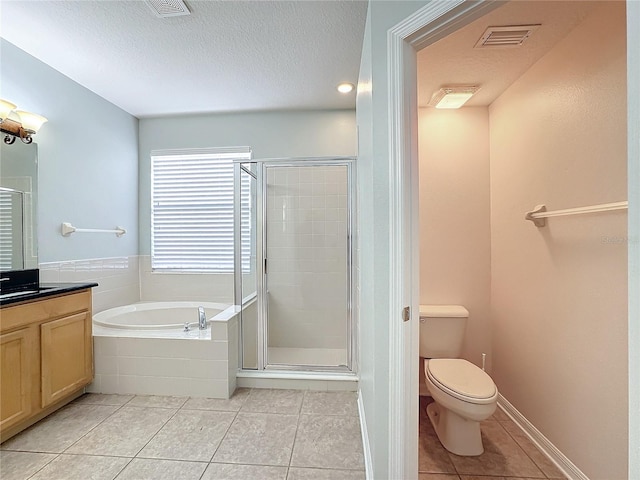 full bathroom with tile patterned flooring, toilet, independent shower and bath, vanity, and a textured ceiling