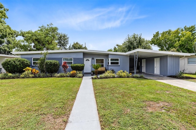 view of front facade featuring a front yard and a carport