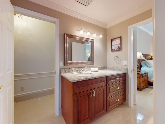 bathroom featuring crown molding and vanity