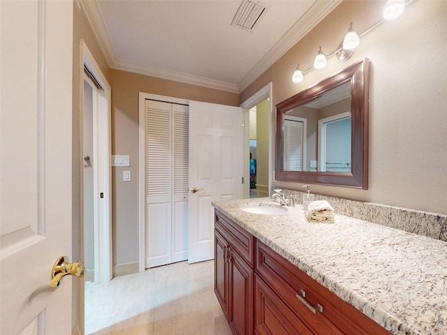 bathroom featuring crown molding and vanity