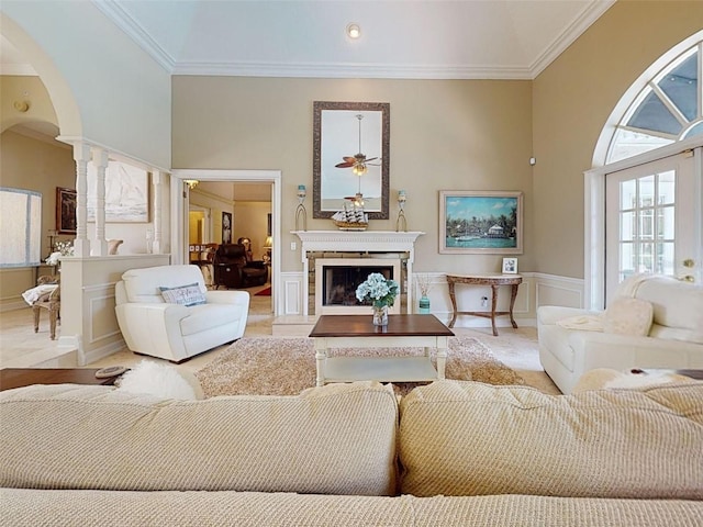 living room with crown molding and ceiling fan