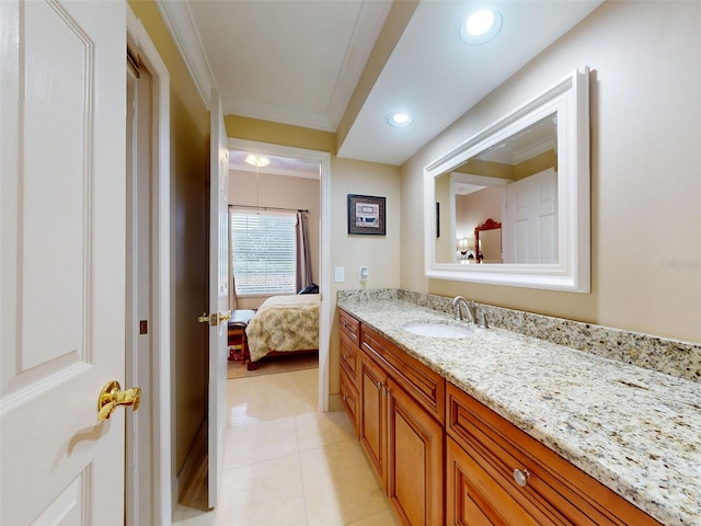 bathroom featuring crown molding, vanity, and tile patterned flooring