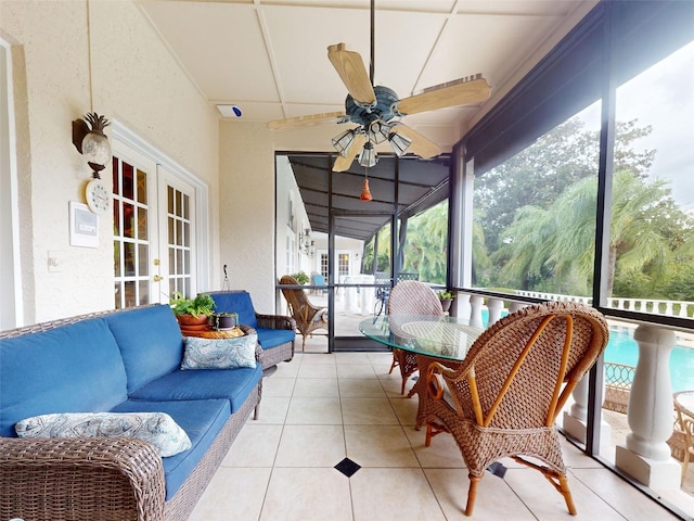 sunroom / solarium featuring ceiling fan and french doors