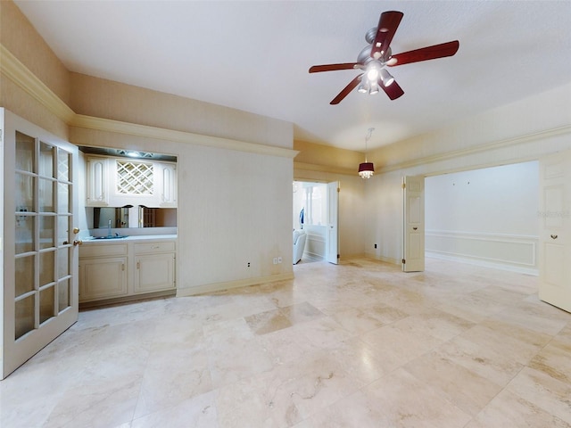 unfurnished living room with ceiling fan and sink