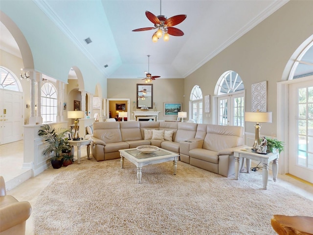 carpeted living room with high vaulted ceiling, ornamental molding, and ceiling fan