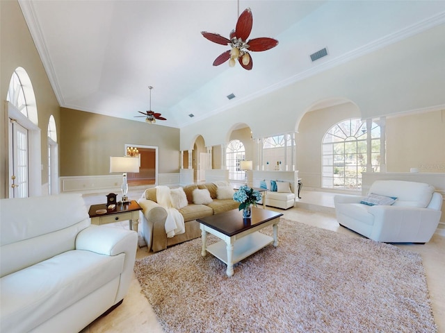 living room with lofted ceiling, ornamental molding, and ceiling fan