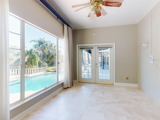 interior space featuring french doors, ceiling fan, and ornamental molding