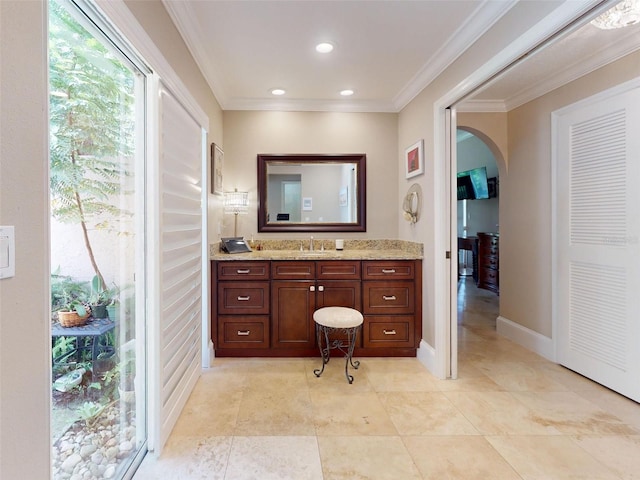 bathroom featuring crown molding and vanity