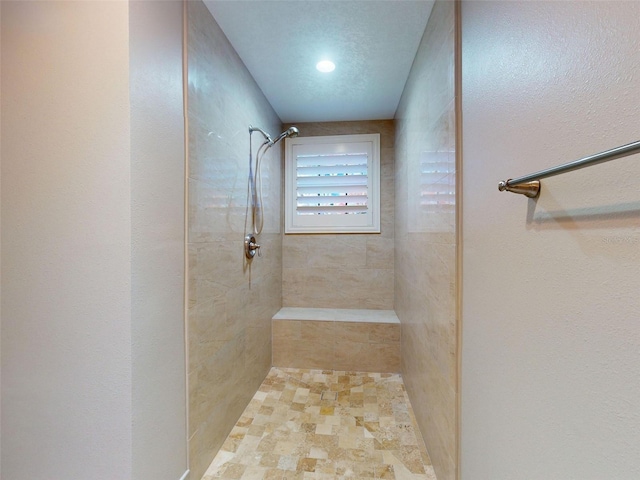 bathroom with a tile shower