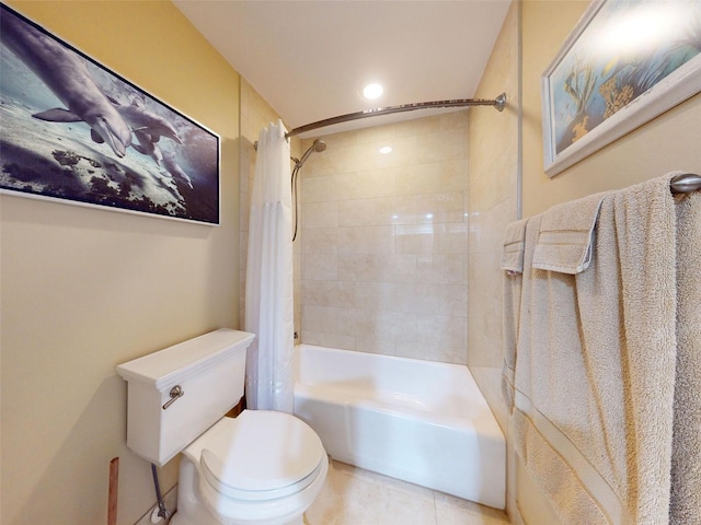 bathroom with tile patterned floors, toilet, and shower / tub combo