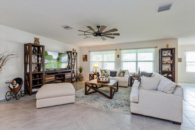 tiled living room featuring ceiling fan