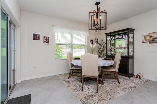 dining room with a notable chandelier and light tile patterned floors