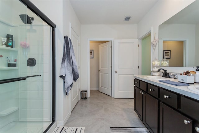 bathroom with vanity, walk in shower, and tile patterned floors