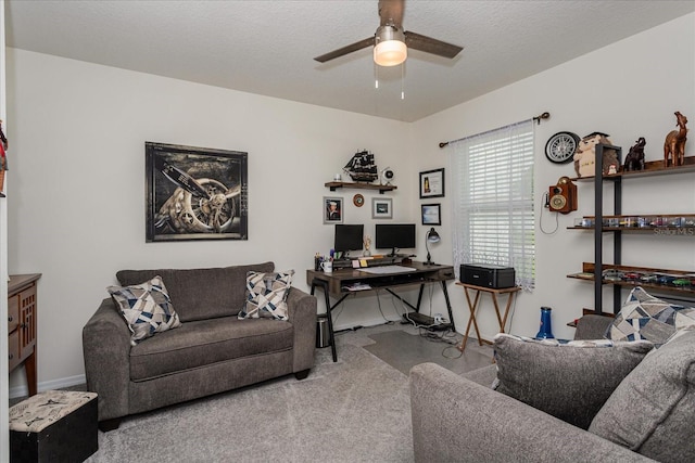 living room with a textured ceiling, light colored carpet, and ceiling fan