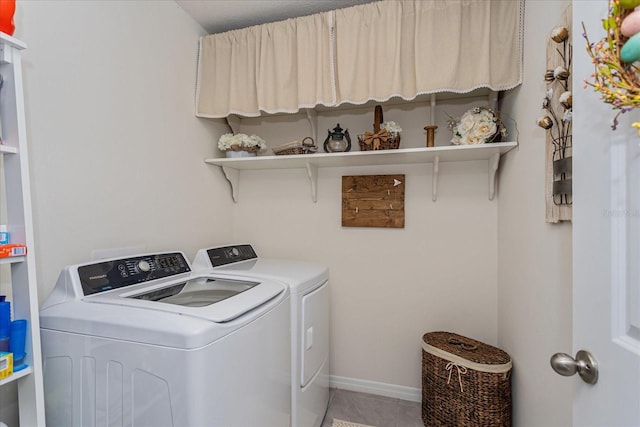 laundry room featuring tile patterned flooring and washing machine and dryer