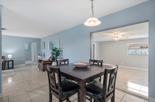 tiled dining area with ceiling fan