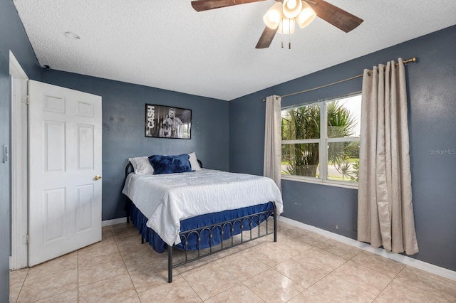 tiled bedroom with a textured ceiling and ceiling fan