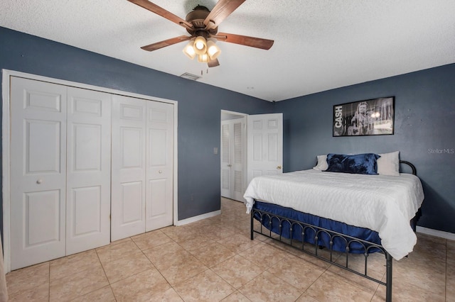 tiled bedroom featuring a textured ceiling and ceiling fan