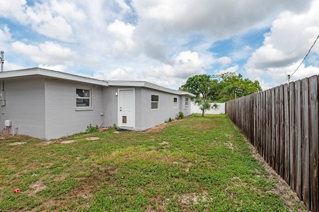 back of property with a lawn