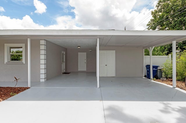 view of vehicle parking with a carport