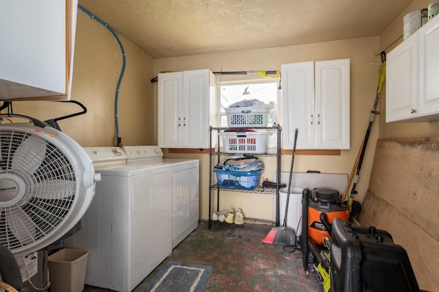 washroom with cabinets, independent washer and dryer, and a textured ceiling