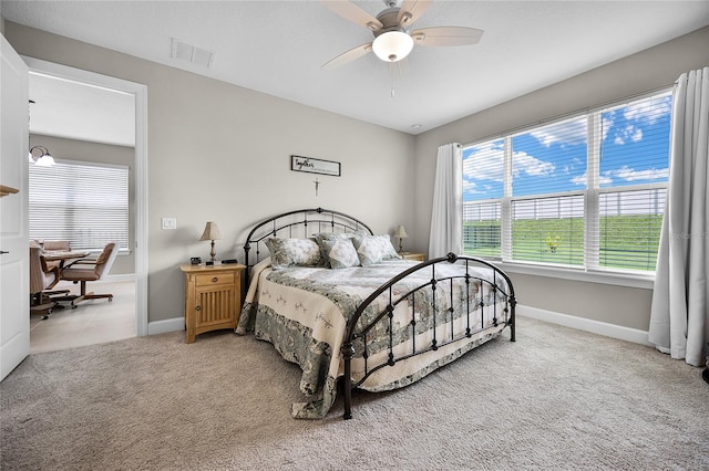 bedroom featuring light colored carpet and ceiling fan