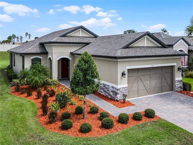 view of front facade featuring a front yard and a garage