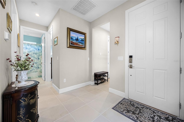 entryway with light tile patterned floors