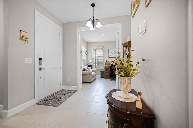 tiled entrance foyer with a notable chandelier