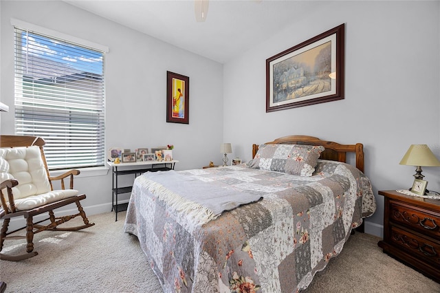 bedroom with ceiling fan, light carpet, and multiple windows