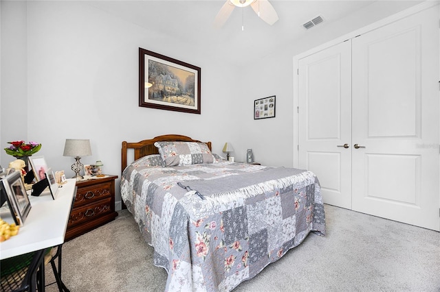 carpeted bedroom with a closet and ceiling fan