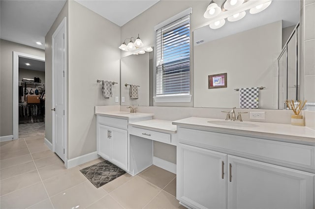 bathroom featuring vanity, walk in shower, and tile patterned floors