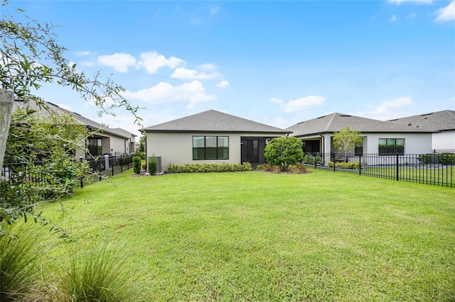 rear view of house with a yard