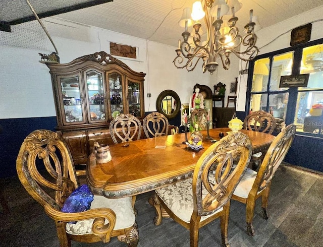 carpeted dining area featuring a chandelier