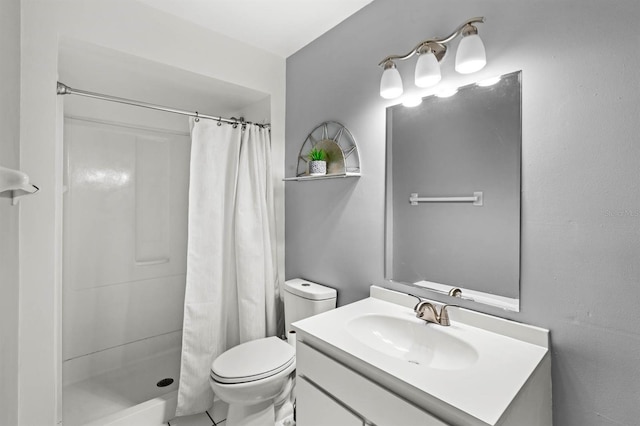 bathroom featuring vanity, toilet, and a shower with curtain