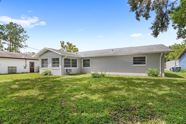 back of property featuring a yard