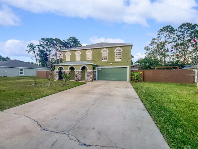 view of front of property featuring a garage and a front yard