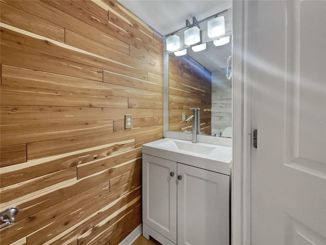 bathroom with wooden walls and vanity