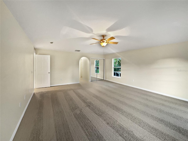 carpeted spare room featuring ceiling fan