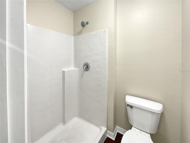 bathroom featuring toilet and walk in shower