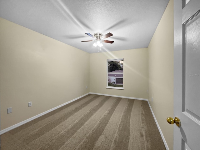 spare room with ceiling fan, carpet, and a textured ceiling