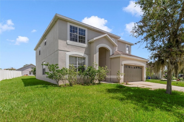 view of front of property with a front lawn, fence, concrete driveway, stucco siding, and an attached garage