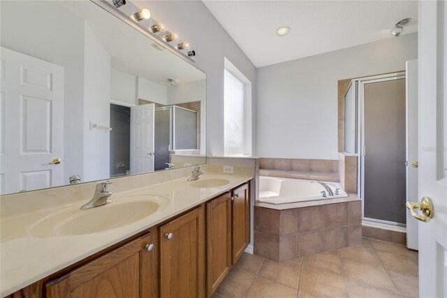 bathroom featuring vanity, plus walk in shower, and tile patterned flooring