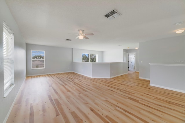 spare room featuring hardwood / wood-style floors, ceiling fan, and a textured ceiling