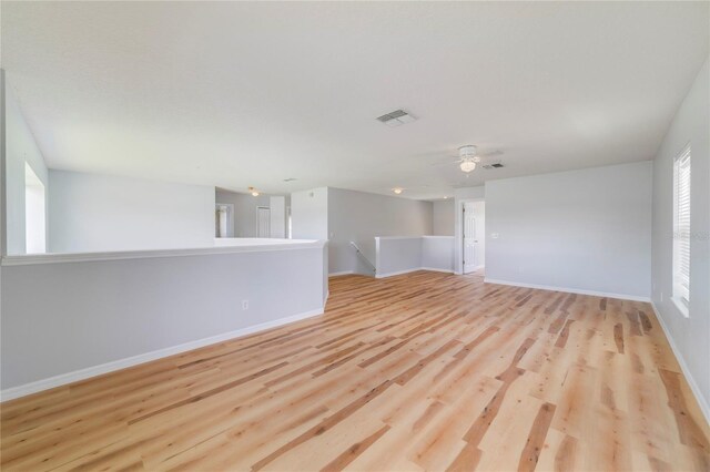 empty room with ceiling fan and hardwood / wood-style floors