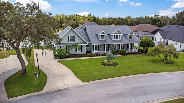 view of front of home with a front yard and a porch