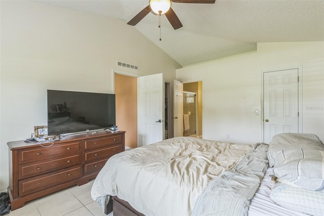 bedroom featuring lofted ceiling, ceiling fan, a textured ceiling, and light tile patterned flooring