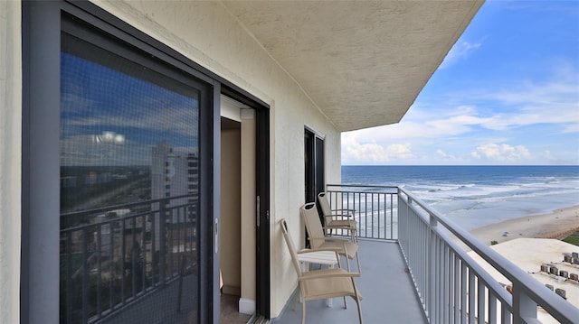 balcony with a beach view and a water view