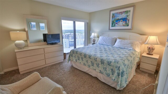 bedroom with carpet and access to outside