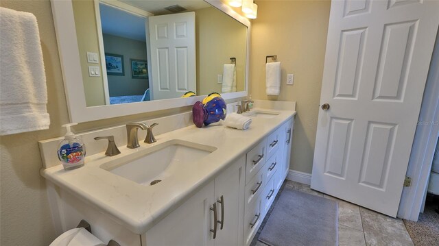 bathroom featuring tile patterned flooring and vanity